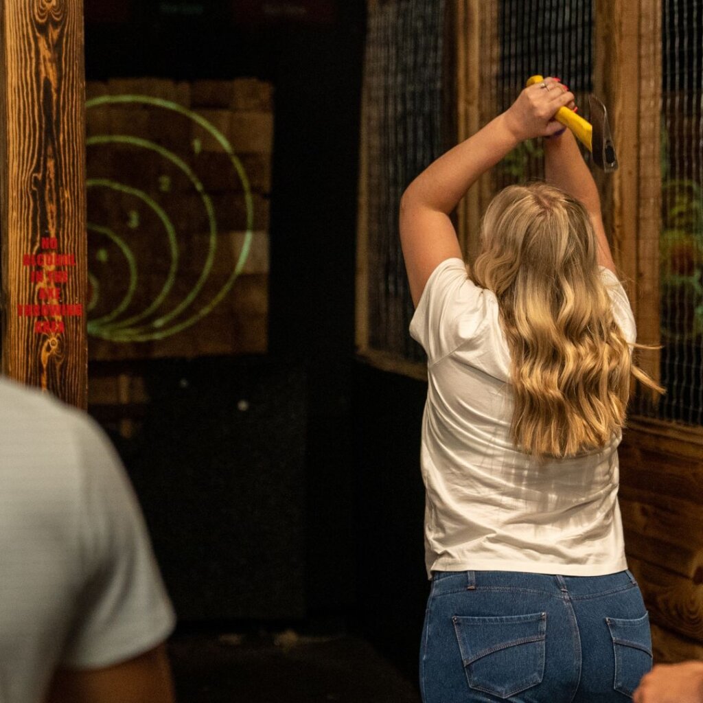 axe throwing girl at high caliber yes girls can throw axes